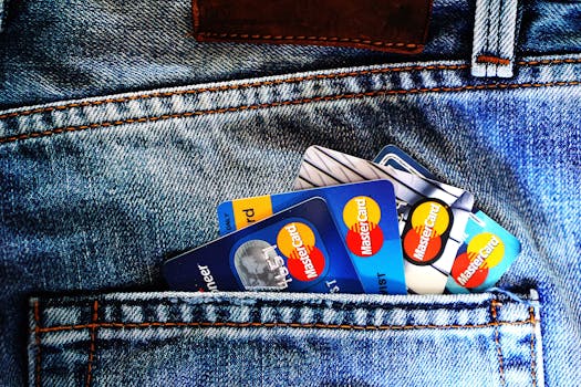 Close-up of a denim pocket with multiple credit cards, illustrating finance and fashion.